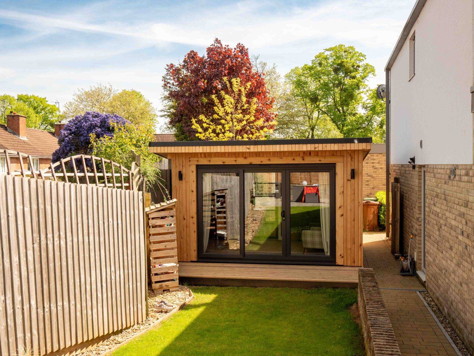 Cedar-clad garden lounge and office with decking, built by Cube Garden Rooms in Cheltenham